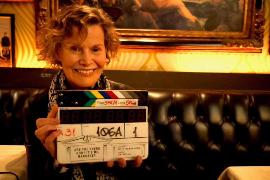 Judy Blume holding a clapperboard on the set of the Are You There God? It's Me Margaret movie