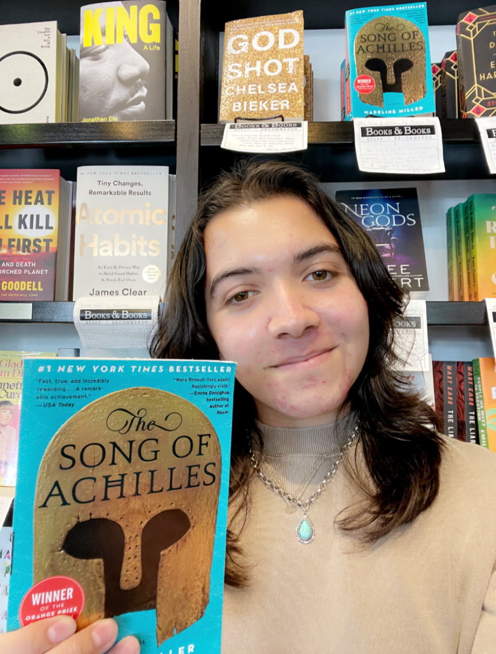 Bookseller Alexander holding The Song of Achilles by Madeline Miller