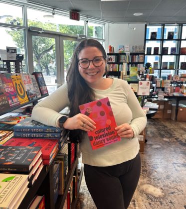 Emily with an ARC of Colored Television by Danzy Senna in the bookstore